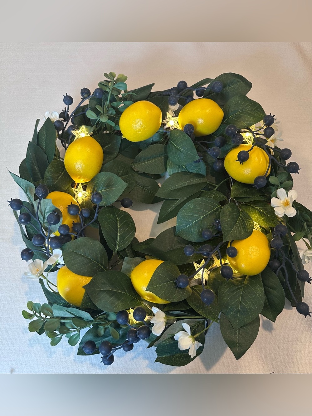 Lemon lighted wreath. 20in. Blueberry, white flowers and greenery accents.
